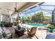 Screened-in lanai featuring a refreshing in-ground pool and outdoor seating at 15422 Starling Crossing Dr, Lithia, FL 33547