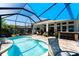 Screened-in pool with covered patio, outdoor bar area and tropical landscape at 15422 Starling Crossing Dr, Lithia, FL 33547