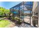 Screened-in pool area with blue umbrella and lush tropical landscaping at 15422 Starling Crossing Dr, Lithia, FL 33547