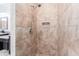 Tiled shower with a rainfall shower head and mounted chrome hardware at 15422 Starling Crossing Dr, Lithia, FL 33547