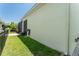 View of a manicured side yard with lush lawn and a screened in porch area at 15422 Starling Crossing Dr, Lithia, FL 33547
