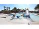 Community splash pad and playground for children with colorful water features and nearby palm trees at 15422 Starling Crossing Dr, Lithia, FL 33547