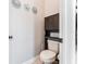 Efficient half bathroom with storage cabinet and a modern, clean aesthetic at 15422 Starling Crossing Dr, Lithia, FL 33547