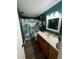 A creatively decorated bathroom with a spacious vanity, an octopus shower curtain, and stylish fixtures at 16035 Grass Lake Dr, Tampa, FL 33618
