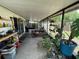 Inviting covered patio perfect for gardening, dining, and lounging, equipped with plants and outdoor furniture at 16035 Grass Lake Dr, Tampa, FL 33618
