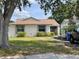 Charming single-story home with a well-maintained lawn and mature trees at 16035 Grass Lake Dr, Tampa, FL 33618
