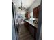 Galley kitchen featuring wood cabinets and granite countertops at 16035 Grass Lake Dr, Tampa, FL 33618