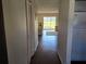 Inviting hallway leading to a bright living area with hardwood floors and ample storage at 1624 Stickney Point Rd # 24-101, Sarasota, FL 34231