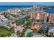 Overhead view of condo featuring a community pool, tennis courts, and landscaping at 17735 Gulf Blvd # 304, Redington Shores, FL 33708