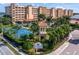 Bahia Vista community featuring a tennis court, lush landscaping, and picturesque buildings with Mediterranean-style architecture at 17735 Gulf Blvd # 304, Redington Shores, FL 33708