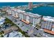 Coastal building featuring palm trees, landscaping, and parking at 17735 Gulf Blvd # 304, Redington Shores, FL 33708