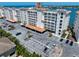 Coastal building featuring palm trees, landscaping and a parking lot at 17735 Gulf Blvd # 304, Redington Shores, FL 33708