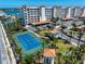 Bahia Vista waterfront community with a tennis court, lush landscaping, covered parking, and Mediterranean-style buildings at 17735 Gulf Blvd # 304, Redington Shores, FL 33708