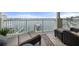 Private balcony with comfortable seating, offering scenic views of the waterfront and boat docks at 17735 Gulf Blvd # 304, Redington Shores, FL 33708