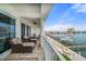 Waterfront condo balcony with comfortable seating area overlooking beautiful marina and waterfront views at 17735 Gulf Blvd # 304, Redington Shores, FL 33708