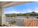 View from the balcony, showcasing a parking area with palm trees and residential homes at 17735 Gulf Blvd # 304, Redington Shores, FL 33708