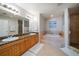 Spacious primary bathroom with double vanity, soaking tub with tile surround and glass enclosed shower at 17735 Gulf Blvd # 304, Redington Shores, FL 33708