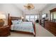 Bedroom featuring a water view, neutral carpet, and dark wood furnishings at 17735 Gulf Blvd # 304, Redington Shores, FL 33708