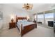Bedroom featuring a water view, neutral carpet, and sliding glass doors to a balcony at 17735 Gulf Blvd # 304, Redington Shores, FL 33708