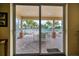 View from interior of screened in patio area with exterior furniture, pool, and palm trees at 17735 Gulf Blvd # 304, Redington Shores, FL 33708