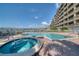 Resort-style pool and hot tub with waterfront views and deck loungers for relaxing in the sun at 17735 Gulf Blvd # 304, Redington Shores, FL 33708