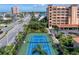 Aerial shot of condo complex with a well-maintained tennis court and nearby parking at 17735 Gulf Blvd # 304, Redington Shores, FL 33708