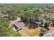 Aerial view of a fenced property, with an outbuilding, and a home with beautiful trees in a serene setting at 18902 Spring Hollow Dr, Lutz, FL 33559
