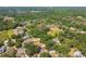Aerial view of a neighborhood with mature trees, spacious properties, and green spaces in a peaceful environment at 18902 Spring Hollow Dr, Lutz, FL 33559