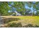 Expansive backyard with mature trees, fencing, detached garage and plenty of room to roam at 18902 Spring Hollow Dr, Lutz, FL 33559