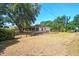 A view of the home's spacious backyard, with mature trees and full fencing at 18902 Spring Hollow Dr, Lutz, FL 33559