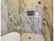 Stylish bathroom featuring a glass shower with marble surround, built-in seat, and modern fixtures at 18902 Spring Hollow Dr, Lutz, FL 33559