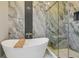 Elegant bathroom showcasing a luxurious soaking tub, glass enclosed shower, and modern finishes at 18902 Spring Hollow Dr, Lutz, FL 33559