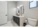 Bathroom featuring double vanity, elegant mirrors, and toilet at 18902 Spring Hollow Dr, Lutz, FL 33559