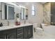 Luxurious bathroom features double vanities, a soaking tub, and modern fixtures for a spa-like experience at 18902 Spring Hollow Dr, Lutz, FL 33559