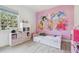 bedroom with princess mural, pink accents, and window at 18902 Spring Hollow Dr, Lutz, FL 33559
