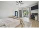 Well-lit bedroom with wood floors, sliding glass doors and an office area at 18902 Spring Hollow Dr, Lutz, FL 33559