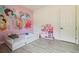 bedroom with princess mural and pink toy kitchen set at 18902 Spring Hollow Dr, Lutz, FL 33559