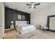 Well-lit bedroom showcases a statement wall, ceiling fan, and neutral toned decor for a peaceful ambiance at 18902 Spring Hollow Dr, Lutz, FL 33559