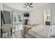 Bright bedroom with wood floors, a ceiling fan, and a sliding glass door to outdoor area at 18902 Spring Hollow Dr, Lutz, FL 33559