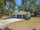 Home with a two-car garage and long driveway at 18902 Spring Hollow Dr, Lutz, FL 33559