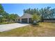 Exterior angle shot showcasing a home with a well-maintained lawn and a convenient two-car garage at 18902 Spring Hollow Dr, Lutz, FL 33559