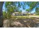 Lovely home with a well-manicured lawn, mature trees, and a convenient two-car garage at 18902 Spring Hollow Dr, Lutz, FL 33559