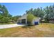 A wide driveway leads to a two-car garage in this attractive home at 18902 Spring Hollow Dr, Lutz, FL 33559