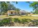 Inviting property with a well-manicured lawn, and a spacious two-car garage at 18902 Spring Hollow Dr, Lutz, FL 33559