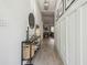 Bright hallway with modern decor, wood floors, and elegant wainscoting at 18902 Spring Hollow Dr, Lutz, FL 33559