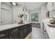 Modern kitchen island featuring a white countertop, dark cabinetry, and pendant lighting at 18902 Spring Hollow Dr, Lutz, FL 33559