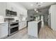 Modern kitchen with an island, stainless steel appliances, and backyard views at 18902 Spring Hollow Dr, Lutz, FL 33559