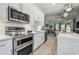 Modern kitchen with stainless steel appliances, white cabinetry, and stylish backsplash at 18902 Spring Hollow Dr, Lutz, FL 33559