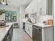 Contemporary kitchen with island, stainless appliances, and tile backsplash at 18902 Spring Hollow Dr, Lutz, FL 33559