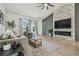 Inviting living room showcasing a stone fireplace, hardwood floors, and lots of natural light at 18902 Spring Hollow Dr, Lutz, FL 33559